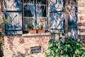 Old house window with blue shutters Royalty Free Stock Photo