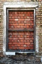 Old house window sealed with red bricks Royalty Free Stock Photo