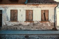 An old house with windows closed with wooden rickety shutters in Kuldiga, Latvia Royalty Free Stock Photo