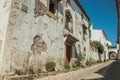 Old house with worn plaster wall and wooden door