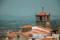 Old houses and church steeple with clock at Monsanto Royalty Free Stock Photo