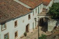 Old houses in cobblestone alley and passageway under arch