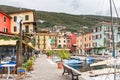 Old houses are located on the promenade with a marina, motor boats and yachts on the shores of Lake Garda in Lazise town, in Royalty Free Stock Photo