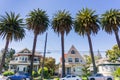 Old houses and palm trees on a street in downtown San Jose, California