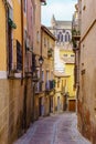 Old houses in a picturesque alley in the medieval city of Toledo