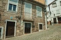 Old houses with stone wall in a deserted alley Royalty Free Stock Photo