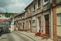 Old houses with stone wall in a deserted alley Royalty Free Stock Photo
