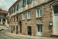 Old houses with stone wall in a deserted alley Royalty Free Stock Photo