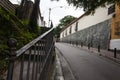 Old houses, vegetation, leafy trees, lonely narrow street and old iron railing with ornament and a bit of rust El Hatillo Miranda