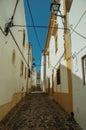 Old houses with whitewashed wall in alley on slope Royalty Free Stock Photo