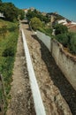 Old houses and worn whitewashed wall in cobblestone alley Royalty Free Stock Photo