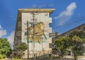 An old housing complex wall in the vicinity of the American Village in Okinawa, where monkeys and other animals are painted