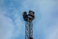 Old huge industrial spot light lamp system on blue sky background. Aged metal tower frame construction with powerful halogen and Royalty Free Stock Photo