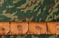 Old hunting cartridges and bandoleer on camouflage Royalty Free Stock Photo