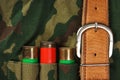 Old hunting cartridges and bandoleer on camouflage Royalty Free Stock Photo