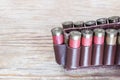 Old hunting cartridges in bandoleer on a wooden table Royalty Free Stock Photo