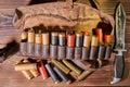 Old hunting cartridges and bandoleer on a wooden table