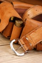 Old hunting cartridges and bandoleer on a wooden table Royalty Free Stock Photo