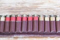 Old hunting cartridges in bandoleer on a wooden table