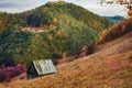 An old hut in autumn mountain landscape in infrared