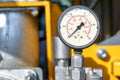 Old hydraulic pressure gauge on yellow equipment Royalty Free Stock Photo