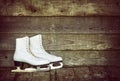 Old ice skates against rustic background Royalty Free Stock Photo