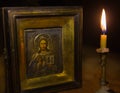 Old icon of Jesus Christ and a candle Royalty Free Stock Photo
