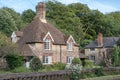 Old idilic country brick cottage in chocolate box touristic setting