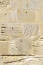 Old idyllic, beautifully restored sandstone wall of a historic building of yellow sandstone with various surface structure, some