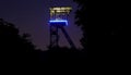 Old illuminated coal mine tower in germany Royalty Free Stock Photo