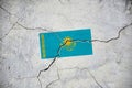 An old image of the flag of Kazakhstan on a wall with a crack