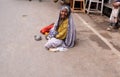 Old Indian beggar waits for alms on a street in Pushkar, India