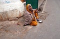 Old Indian beggar waits for alms on a street in Pushkar, India