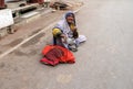 Old Indian beggar waits for alms on a street in Pushkar, India