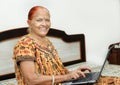 Old indian lady happy using laptop. Royalty Free Stock Photo