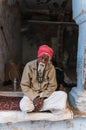 An old Indian man with a red turban