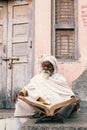 Old indian sadhu reading scriptures.