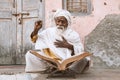 Old indian sadhu reading scriptures.