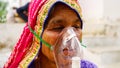 Woman suffering from Covid 19 disease. Old woman admitted in hospital and inhaling emergency oxygen with canula mask