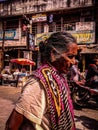 Old Indian women walking in street in tension