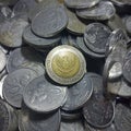 Old Indonesia money 1000 rupiah coin from year 2000 in stack full of other indonesia small changes coin