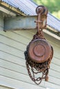 Old industrial chain hoist for reduce working load and lifting heavy object, mechanical hoist, gear hoist for one man operation Royalty Free Stock Photo