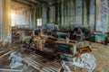 Old industrial machine tool. Rusty metal equipment in abandoned overgrown factory Royalty Free Stock Photo