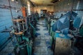 Old industrial machine tools in abandoned workshop. Rusty metal equipment in abandoned factory