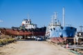 Old industrial ship boat in dry dock for repair, harbor in Greece, sunny day Royalty Free Stock Photo