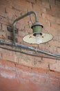 Old insdustrial lamp on the red-brick wall Royalty Free Stock Photo