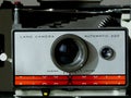 old instant camera frontal close-up view with red and silver face plate Royalty Free Stock Photo