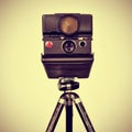 Old instant camera in a tripod Royalty Free Stock Photo
