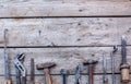 An old instrument. Carpentry. Old, rusty tools lying on a black wooden table. Hammer, chisel, hacksaw, metal wrench.Copy space Royalty Free Stock Photo
