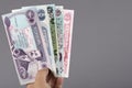 Old Iraqi money in the hand on a gray background Royalty Free Stock Photo